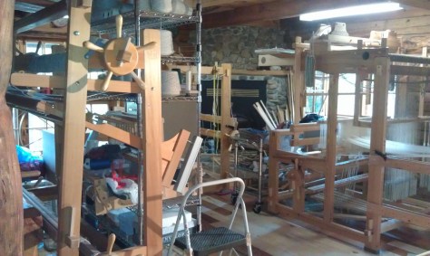 Looms and more pushed to one end of the room.